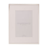 Silverplated photo frame with slim silver edge and wide white mount for a 6 x 4in photo, shown upright on a plain white background.