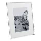 Silverplated photo frame with slim silver edge and wide white mount for a 6 x 4in print, shown at an angle on a plain white background.