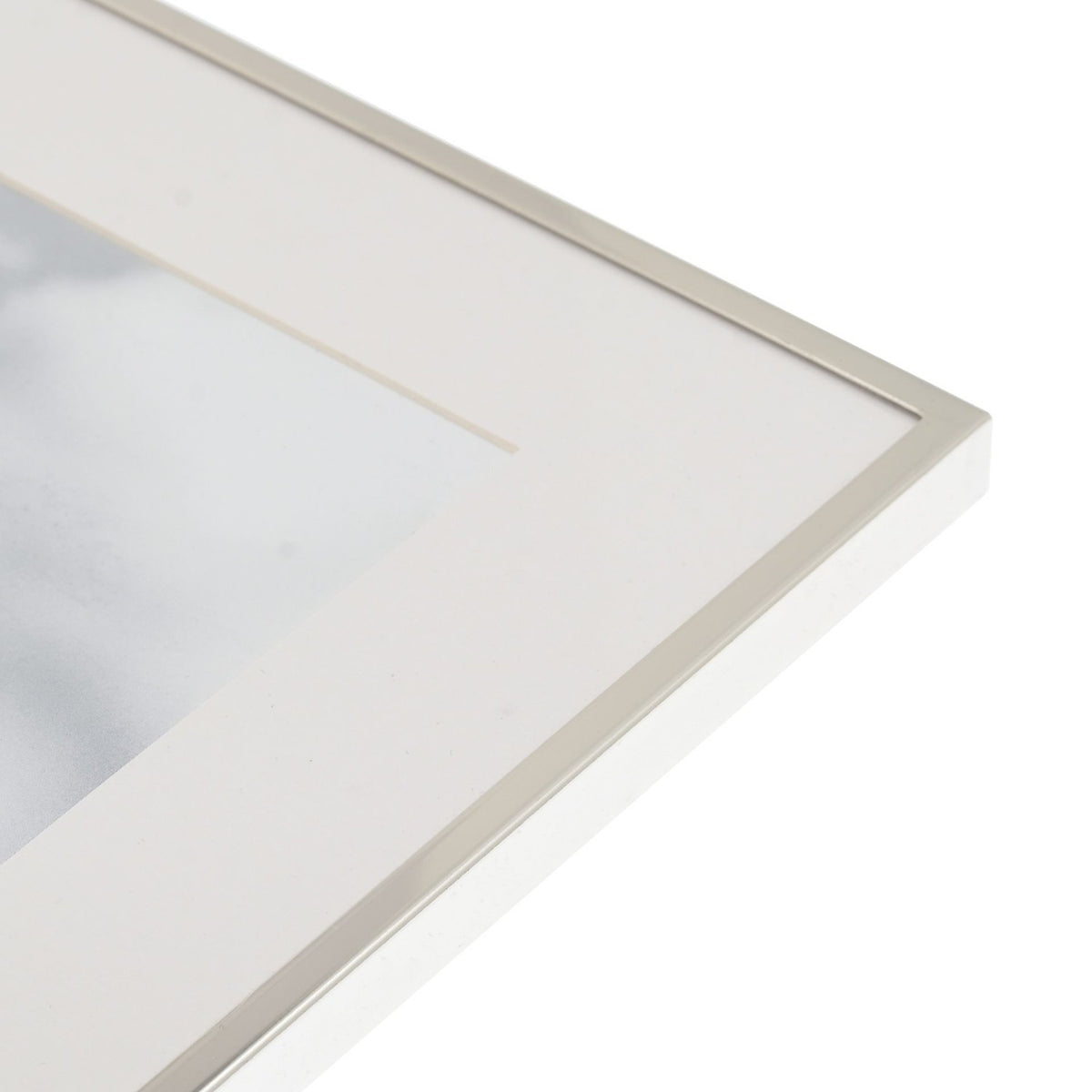 Close-up of the Silverplated Photo Frame 10 x 8in corner, showing the slim polished silver edge and white mount against a plain white background.