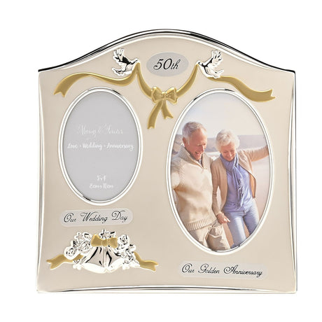50th Anniversary double photo frame with arched silver top, two oval openings, dove and bow details, holding wedding and golden anniversary photos on a cream silverplated finish.
