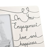 Silver-toned 6x4in photo frame with rectangular photo opening, featuring "On Your Engagement love and happiness" in black script with heart details on a looping thread design.