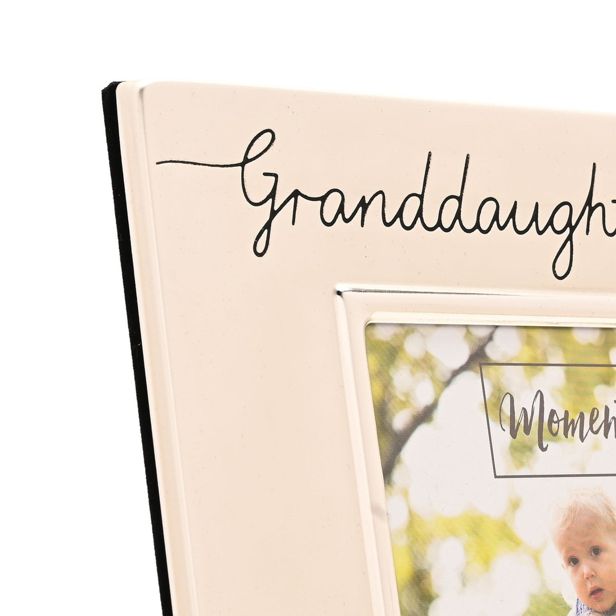 Close-up of the Granddaughter 6 x 4in silverplated photo frame, showing cursive "Granddaught..." script engraved on the satin silver metal border above the photo opening.