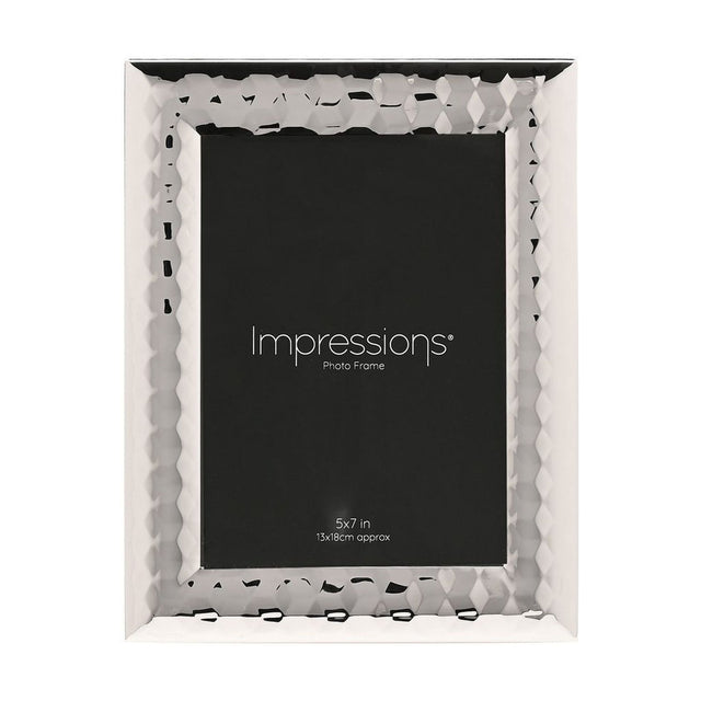 Rectangular silverplated metal photo frame with a faceted, patterned wide border, holding a 5 x 7in black sample insert on a plain white background.