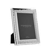 Patterned silverplated metal photo frame, 7x5in, rectangular with a faceted textured border and integrated stand, shown at an angle on a plain white background.
