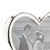 Close-up of the Heart Beaded Silverplated Alloy Photo Frame, 4 x 4in, showing the polished silver finish and beaded inner edge framing a wedding photo.
