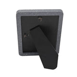 Rear view of the Speckled Rounded Wooden Photo Frame 7 x 5in in grey and white, showing a black back panel, fold-out stand, and hanging hook on a white background.
