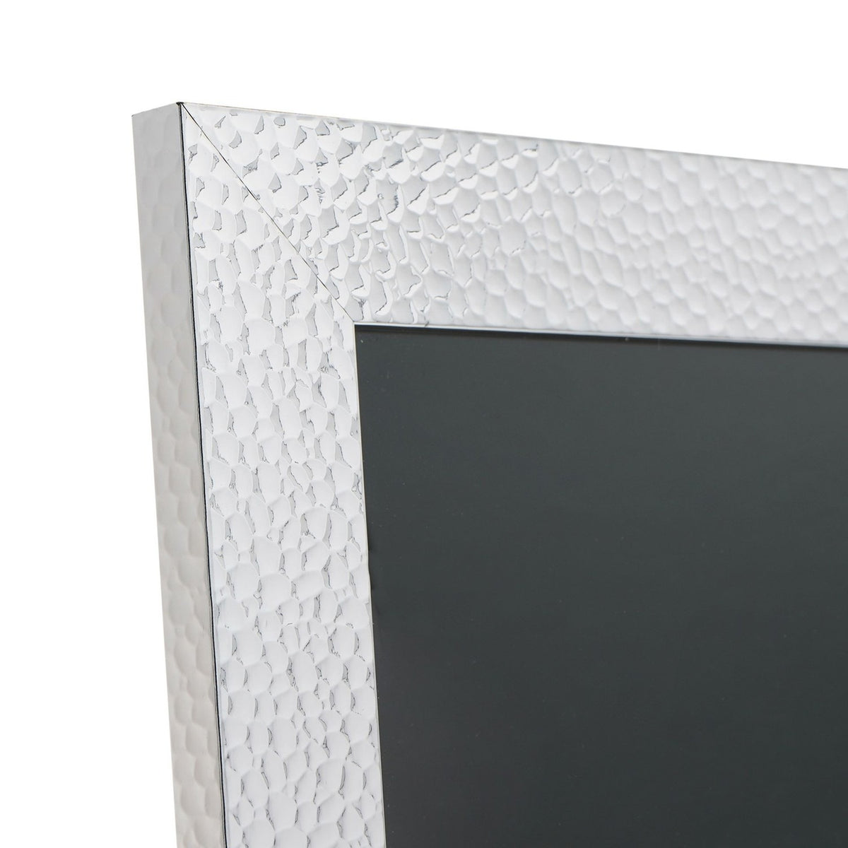Close-up of a rectangular photo frame corner in silver plastic with a hammered effect finish, showing the mitred edge and dark insert against a white background.