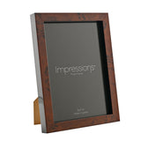 Rectangular photo frame with dark brown burr effect plastic finish, holding a 5x7 in insert, shown at an angle against a plain white background.