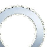 Close-up of the Galaxy LED Crystal Round Table Lamp 10W 6000K in polished chrome, featuring clear faceted segments around the edge and a reflective metallic surface, set against a white background.