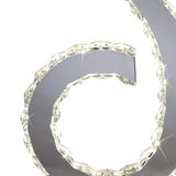 Close-up of a metallic spiral with faceted, crystal-like edges and sparkling white lights—evoking the style of the Galaxy LED Crystal D Shape Table Lamp 12W 4000K in Polished Chrome. Only a portion appears against a white background.