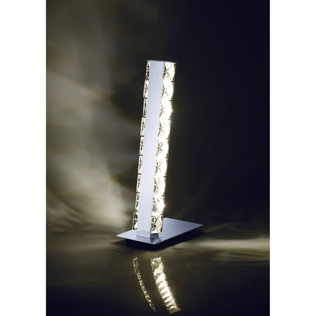 The Galaxy LED Crystal Table Lamp 3W 4000K in Polished Chrome features a textured glass column and chrome base, offering bright, energy-efficient light and modern reflections—a striking accent for contemporary spaces.