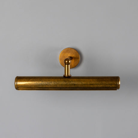 Galle Brass Picture Light IP65 35.5cm, a cylindrical wall light in antique brass with a ball-jointed arm and round wall plate, shown on a plain light grey background.