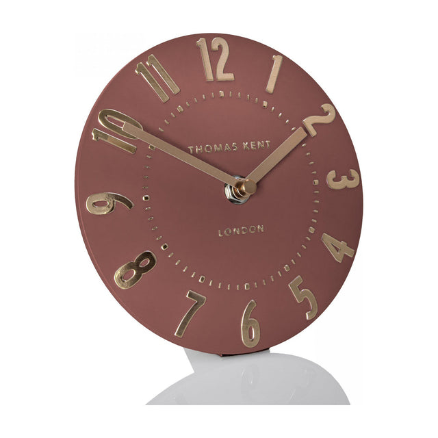 Thomas Kent Mulvorne 6 inch mantel clock with a round auburn dial, raised gold 3D Arabic numerals and slim metal hands on a plain background.