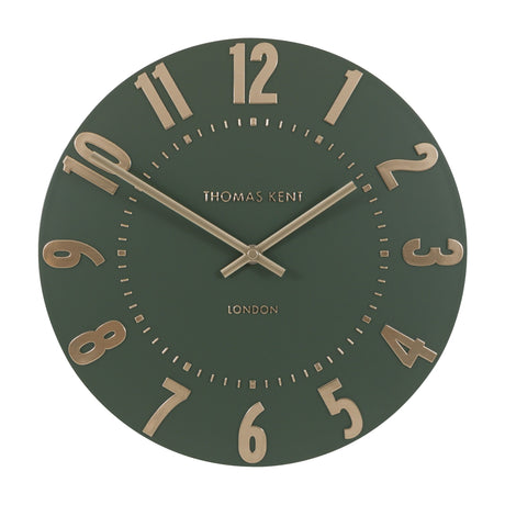 Gallery Direct Mulvorne Wall Clock by Thomas Kent in olive green with raised gold-tone Arabic numerals, slim baton hands and a London-signed matt dial.