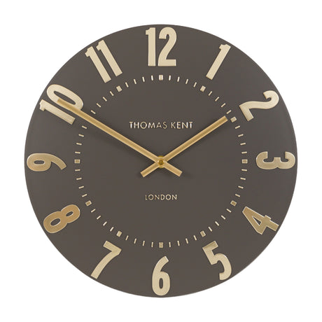 Gallery Direct Mulvorne Wall Clock by Thomas Kent in mocha with raised gold Arabic numerals and slim baton hands on a matt painted dial.
