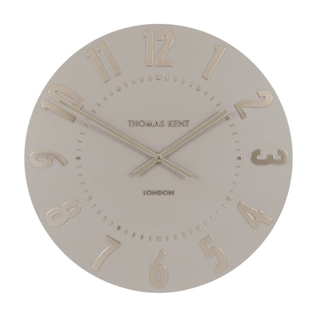 Mulvorne Wall Clock by Gallery Direct with a round silver-grey matt dial, raised gold-tone Arabic numerals, slim baton hands and Thomas Kent London signature.