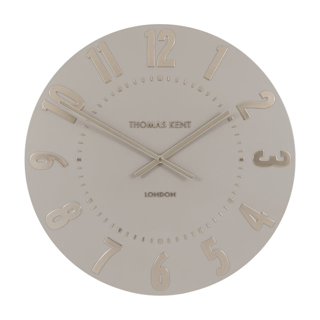 Mulvorne Wall Clock by Gallery Direct with a round silver-grey matt dial, raised gold-tone Arabic numerals, slim baton hands and Thomas Kent London signature.