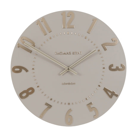 Mulvorne Wall Clock by Gallery Direct with a round silver-grey matt dial, raised gold-tone Arabic numerals, slim baton hands and Thomas Kent London signature.