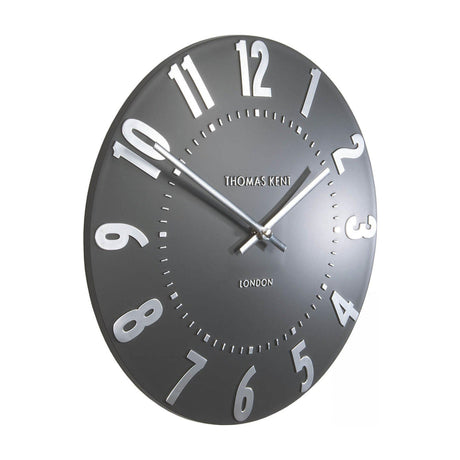 Mulvorne Wall Clock by Thomas Kent in graphite silver, angled view showing raised silver Arabic numerals, slim baton hands and matt painted dial.