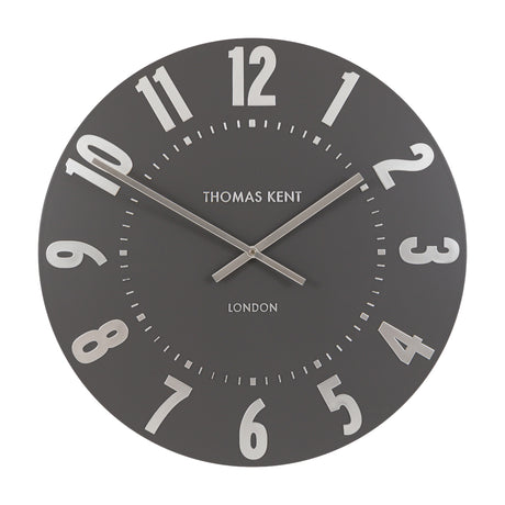 Mulvorne Wall Clock by Thomas Kent in graphite silver, angled view showing raised silver Arabic numerals, slim baton hands and matt painted dial.