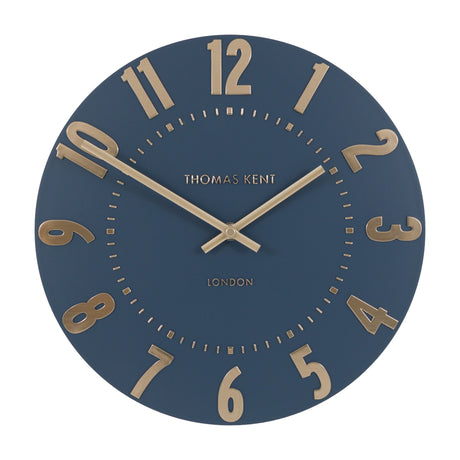 Mulvorne Wall Clock by Gallery Direct, a round Thomas Kent analogue clock with a midnight blue matt dial and raised gold-tone Arabic numerals.