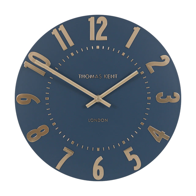 Mulvorne Wall Clock by Gallery Direct, a round Thomas Kent analogue clock with a midnight blue matt dial and raised gold-tone Arabic numerals.