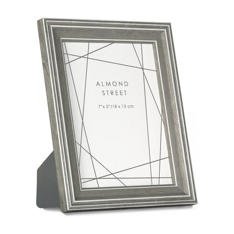 Gallery Direct Kelvane freestanding photo frame in grey wood-effect finish with fine white line detailing, holding a 7x5in portrait print.