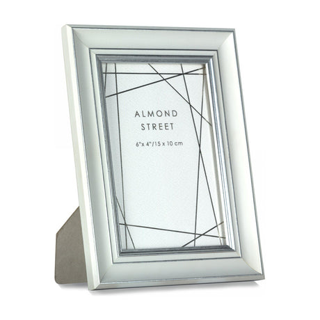 Gallery Direct Holvane portrait photo frame in white with stepped silver-tone inner edge, freestanding on a plain background, holding a 6" x 4" print.