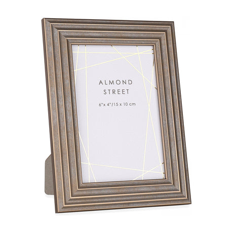 Gallery Direct Hutvorne 6 x 4in photo frame in bronze with a stepped moulded profile and fold-out strut, shown freestanding on a white background.