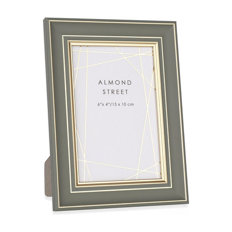 Gallery Direct Ripvane sage photo frame with slim gold inner trim, holding a 6x4in portrait print on a fold-out strut against a white background.