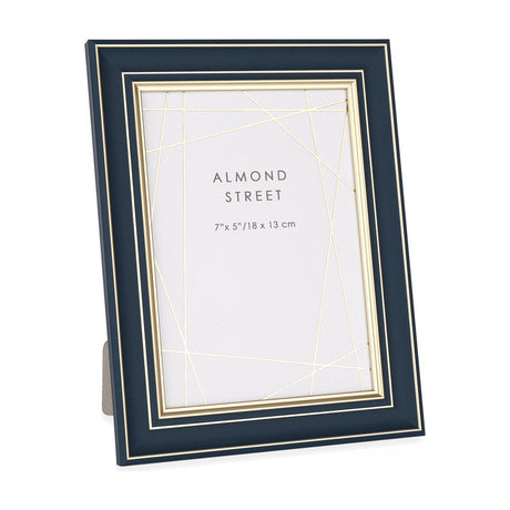 Gallery Direct Arvorne navy photo frame with slim gold trim and inner line, portrait 7x5in freestanding design shown on a plain white background.