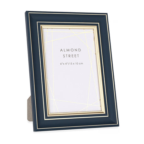 Gallery Direct Arvorne navy photo frame with stepped profile and gold inner trim, holding a 6x4in portrait print, freestanding on a white background.