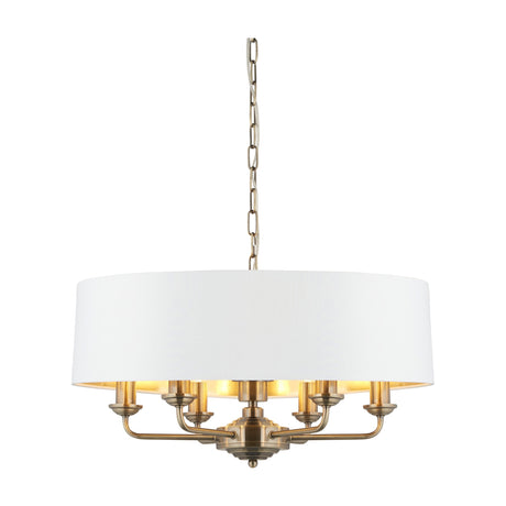 Gallery Direct Clervorne 6 light ceiling pendant with white fabric drum shade and antique brass frame on chain suspension.