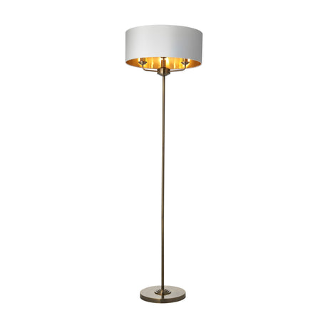 Gallery Direct Clervorne 3-light floor lamp with slim antique brass stem, weighted circular base and white fabric drum shade with gold-tone inner.