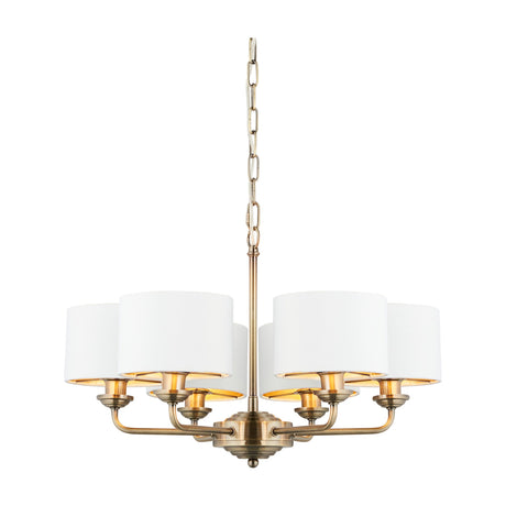 Gallery Direct Clervorne 6 Light Ceiling Pendant with off-white fabric drum shades on an antique brass chain-suspended frame, plain white background.