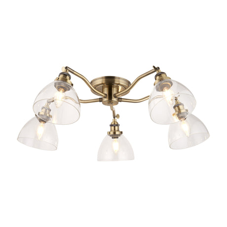 Gallery Direct Sarwen 5 light semi-flush ceiling light in antique brass with five curved arms and clear glass bell-shaped shades on a white background.