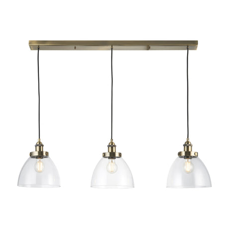 Gallery Direct Sarwen 3 Light Bar Pendant in antique brass with three clear glass dome shades on black flex, shown on a white background.