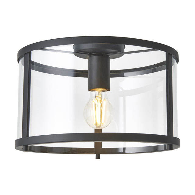 Gallery Direct Hoplora Flush Ceiling Light with black steel drum frame and clear glass shade around a single E27 filament bulb, on white.