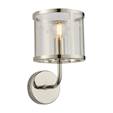Gallery Direct Hoplora Wall Light with a bright nickel cylindrical cage frame, clear glass shade, curved arm, round backplate, and exposed filament bulb.