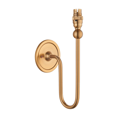 Gallery Direct Norvael wall light fitting in brushed aged brass, featuring an S-shaped steel arm, round backplate and exposed B22 lamp holder with ball detail.