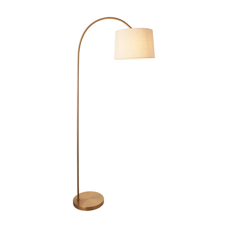 Gallery Direct Carvenne Arc Floor Lamp in warm brass with slim curved steel stem, weighted round base, and tapered cream fabric shade.