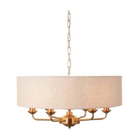 Gallery Direct Clervorne 6-light pendant with vintage brass frame, curved arms and natural linen-look fabric drum shade on chain suspension.