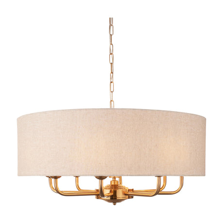 Gallery Direct Clervorne 8 Light Pendant in natural linen-effect drum shade with vintage brass arms and chain suspension on a white background.