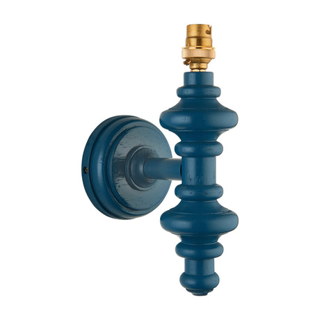 Gallery Direct Carnvenne turned wooden wall light fitting in Marlin Blue with round backplate, spindle-style body and brass B22 lampholder on white.