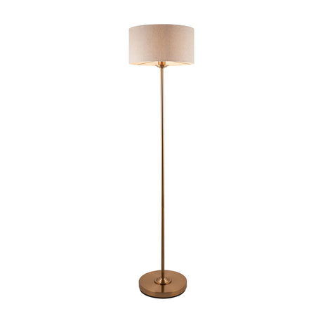 Gallery Direct Clervorne Floor Lamp with natural linen drum shade on a slim antique brass stem and weighted circular base, shown on a white background.