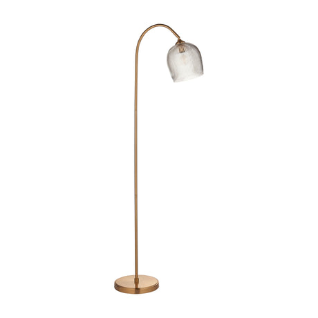 Gallery Direct Vellamis Ribbed Floor Light in brushed aged brass with an arched stem, ribbed clear glass shade and weighted circular base.