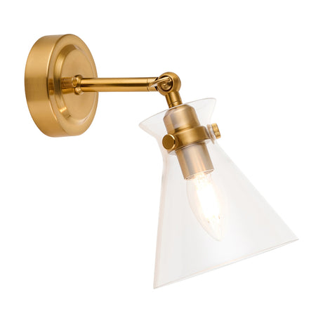 Gallery Direct Hollena wall light in brushed aged brass with a clear glass cone shade, adjustable knuckle joint and lit candle bulb, on a white background.