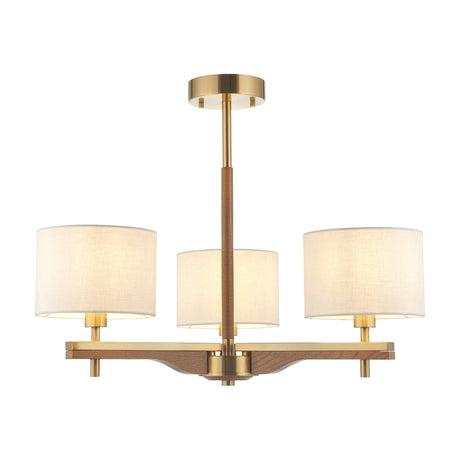 Gallery Direct Wravyn 3 light ceiling light in aged brass with a natural wood column and three off-white fabric drum shades on a plain background.