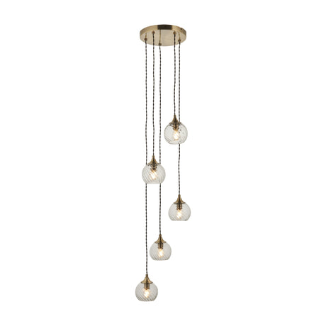 Gallery Direct Amalise Cascade 5-light pendant with clear ribbed glass globes on twisted black flex, staggered from an antique brass ceiling plate.