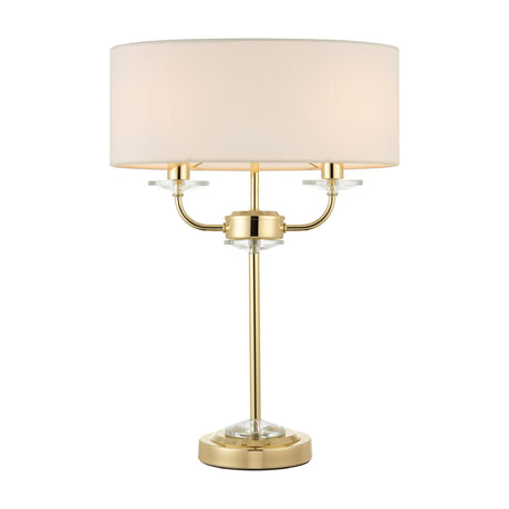 Gallery Direct Ostwyn 2 Light Table Lamp in brass with crystal accents and a vintage white fabric drum shade on a plain white background.